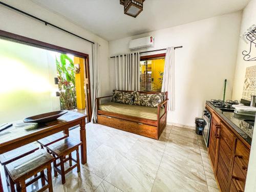 a living room with a couch and a table at Conchas do Mar Residence in Itacaré