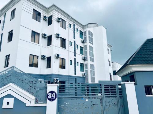 a large white building with a sign in front of it at Kam Apartment and Taverns in Abuja