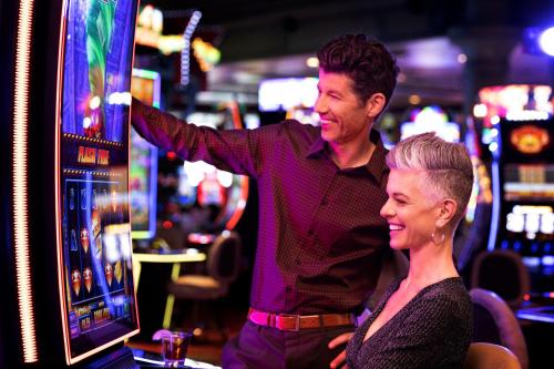a man and a woman playing a video game at Silver Legacy Reno, A Caesars Destination in Reno