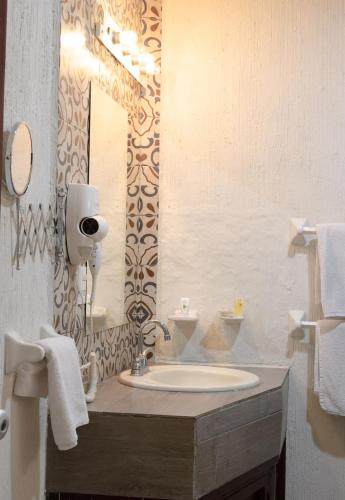 a bathroom with a sink and a mirror at El Marques Hacienda in Guanajuato