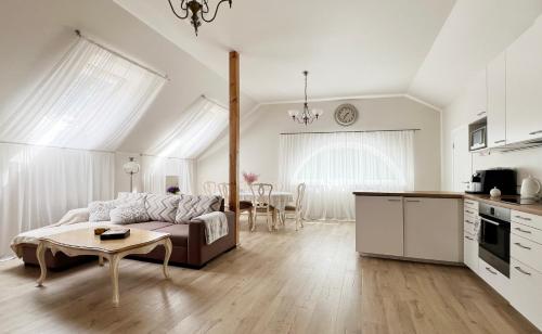a living room with a couch and a table at Beachfront apartment in Jūrmala