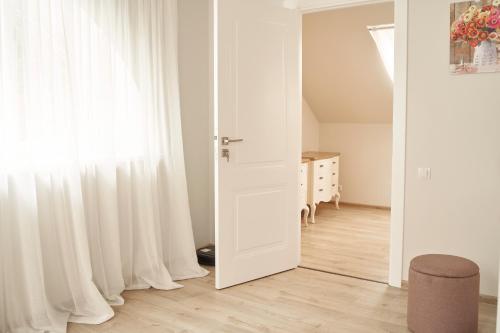 a white door in a room with a window at Beachfront apartment in Jūrmala