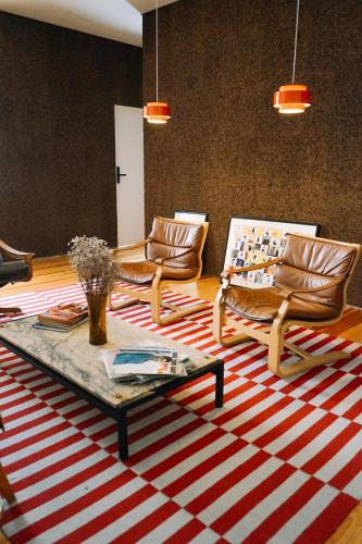 a living room with chairs and a coffee table at samesame living in Lisbon