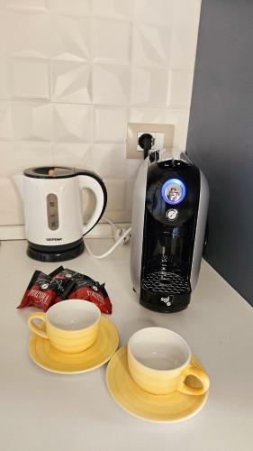 a counter top with a coffee maker and a toaster at The Stopover Suite House 2 in Fiumicino