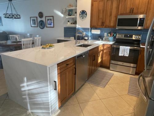 a kitchen with a large island in the middle at Waterfront luxury Villa 42 with sunset views and boat slip townhouse in Marathon