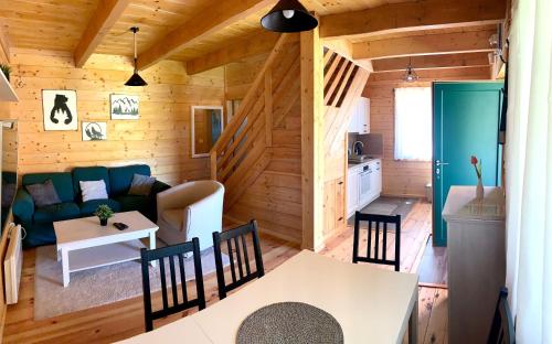 a living room and kitchen in a log cabin at Starry Sky Zlatibor in Krajevi