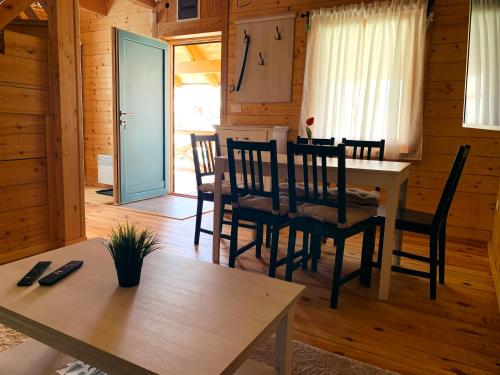 a dining room with a table and chairs in a cabin at Starry Sky Zlatibor in Krajevi