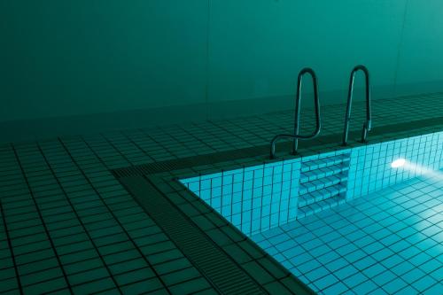 a swimming pool with a tile floor at SETOUCHI RETREAT by Onko Chishin in Matsuyama