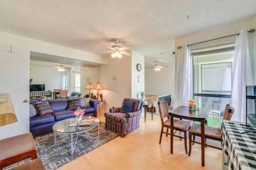 a living room with a blue couch and a table at 3 Mi to Dtwn Fort Worth! Condo with Hot Tub and Pool in Fort Worth