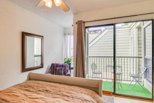 a bedroom with a bed and a balcony at 3 Mi to Dtwn Fort Worth! Condo with Hot Tub and Pool in Fort Worth