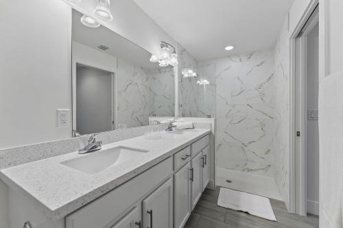 a white bathroom with a sink and a mirror at October Special! Limited-time Discount Book Now! in West Palm Beach