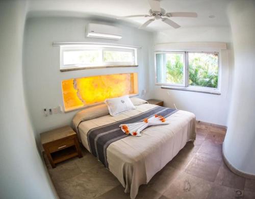 a bedroom with a bed with two stuffed animals on it at Palmar & master suite in Bajos de Chila