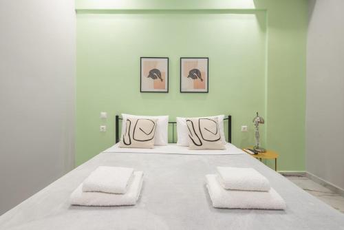 a large white bed with two pillows on it at Athens Stay in Athens