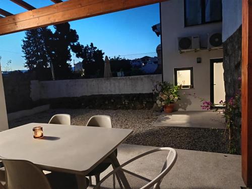 a table and chairs on a patio with a view at Casa Além Da Ponte in Vouzela