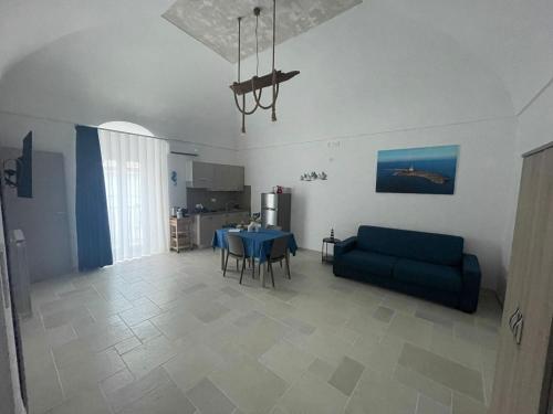 a living room with a blue couch and a table at Il Borgo Apartments in Vieste