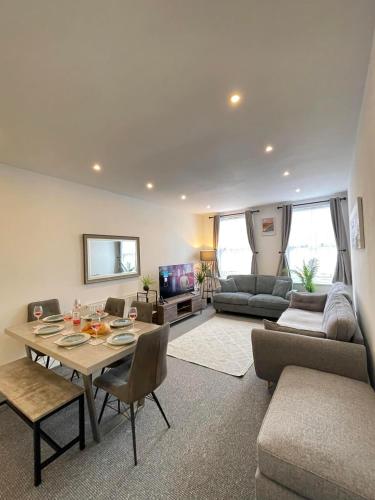 a living room with a table and a couch at Montague Apartment-Spacious, Central & Free Parking in Worthing