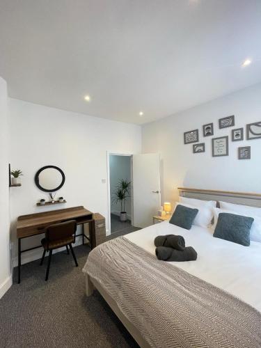 a bedroom with a large bed and a desk at Montague Apartment-Spacious, Central & Free Parking in Worthing