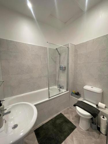 a bathroom with a sink and a toilet and a shower at Montague Apartment-Spacious, Central & Free Parking in Worthing