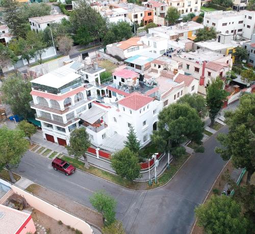 an aerial view of a city with a white building at Suite Chachani in Arequipa