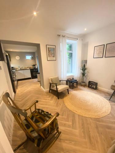 a living room with a chair and a couch at Spacious Town House in Aberdare