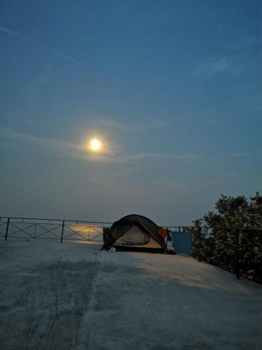 a tent sitting on top of a field with the moon at High Camping in Budva