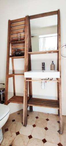 La salle de bains est pourvue d'un lavabo et d'une échelle en bois. dans l'établissement Chambre cosy avec terrasse sur la colline boisée, parking privé, jardin, calme, climatisation, 10 mn pont du Gard num7, à Rochefort-du-Gard