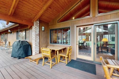 a porch with a wooden table and chairs on a house at Par Paradise in Pinetop