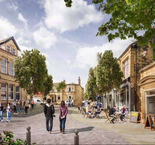 a group of people walking down a street at Southgate Luxury Apartments-Jaquzzi Bath-Private Parking- 2 Min M62 in Elland