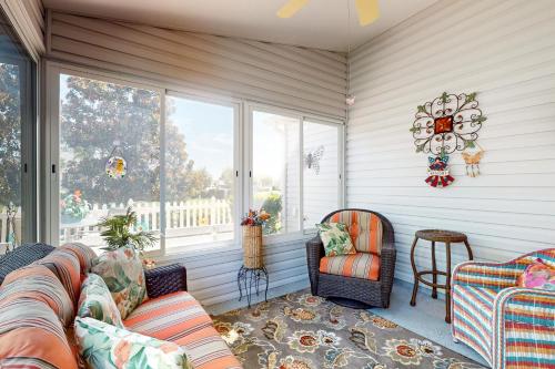 a living room with a couch and chairs and windows at Smith and Davis Retreat in The Villages