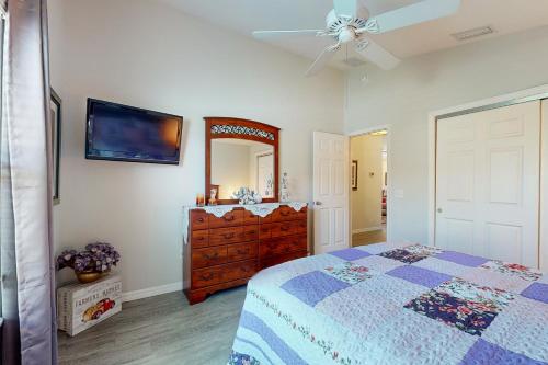 a bedroom with a bed and a dresser and a mirror at Smith and Davis Retreat in The Villages
