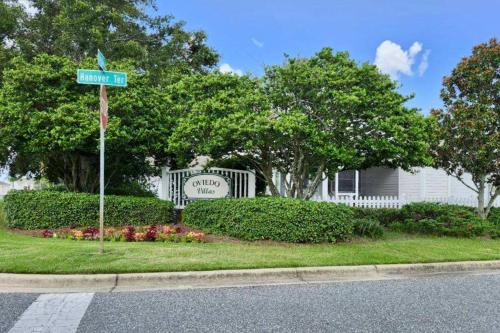a street sign in front of a house with a sign at Smith and Davis Retreat in The Villages