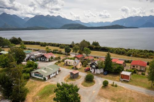 an aerial view of a home next to a lake at Manapouri Holiday Park in Manapouri