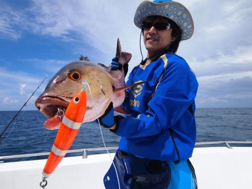 a man on a boat with a fish in its mouth at Hotel Ocean Grand at Hulhumale in Hulhumale