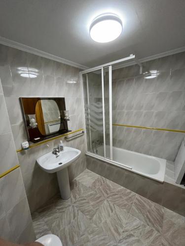 a bathroom with a sink and a shower and a tub at Titanic in Cazorla