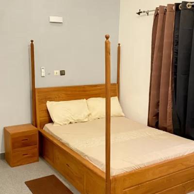 a bedroom with two bunk beds and a night stand at Cristal House in Cotonou