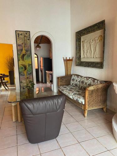 a living room with a couch and a glass table at Hotel Villas Ajijic, Ajijic Chapala Jalisco in Ajijic
