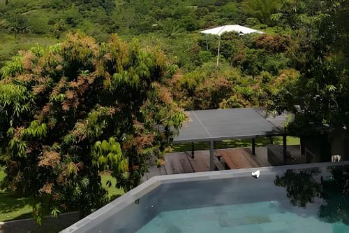 an aerial view of a swimming pool and trees at Descanso total en el mejor clima de Colombia in Anapoima