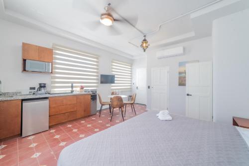 a large bedroom with a large bed and a kitchen at Casa Velasco La Paz in La Paz