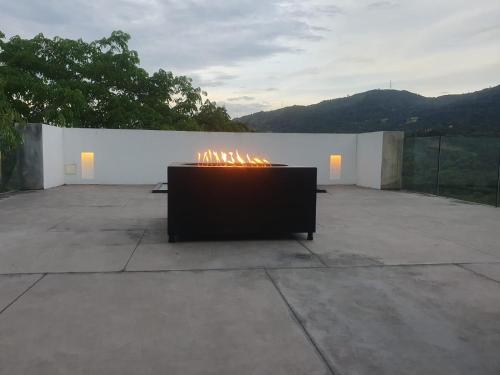 a fire pit sitting on top of a patio at Descanso total en el mejor clima de Colombia in Anapoima