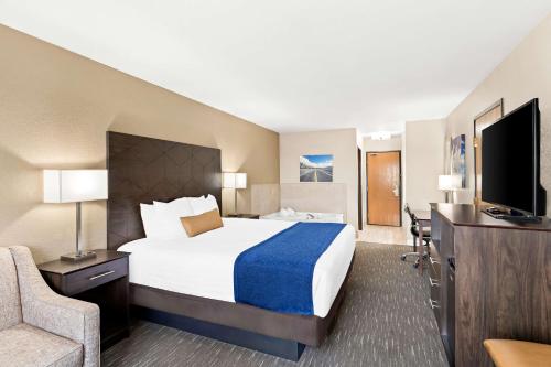 a hotel room with a bed and a television at Best Western Snowflake Inn in Snowflake