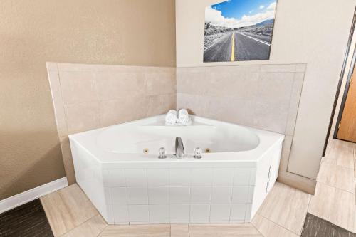 a bathroom with a white tub and a sink at Best Western Snowflake Inn in Snowflake