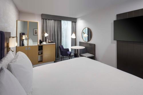 a hotel room with a bed and a desk at DoubleTree by Hilton Manchester Piccadilly in Manchester