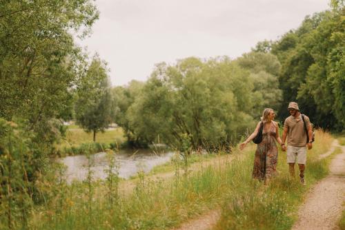 a man and a woman walking down a dirt road at 2Places Side in Lörrach