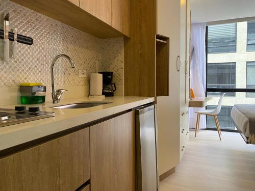 a kitchen with a sink and a counter top at Nuo by Wynwood House in Bogotá