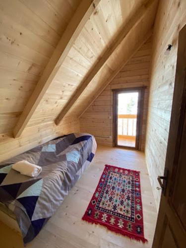 a room in a log cabin with a couch and a rug at Villa Klodi in Boge
