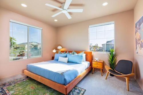 a bedroom with a bed and a ceiling fan at 7BR Pickleball Firepit Outdoor Kitchen Game Room in Coachella