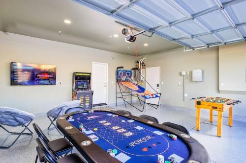 a room with a game table and a video game at 7BR Pickleball Firepit Outdoor Kitchen Game Room in Coachella
