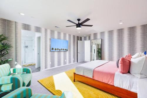 a bedroom with a bed and a ceiling fan at 7BR Pickleball Firepit Outdoor Kitchen Game Room in Coachella