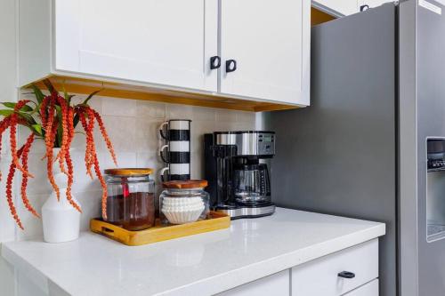 a kitchen counter with a coffee maker on a shelf at 7BR Pickleball Firepit Outdoor Kitchen Game Room in Coachella