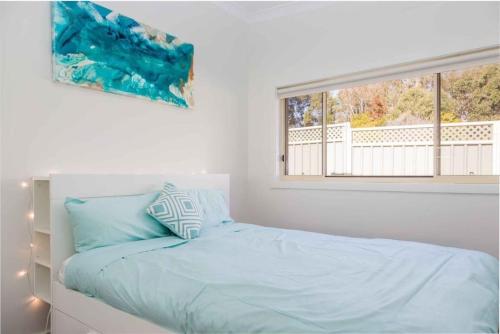 Ένα ή περισσότερα κρεβάτια σε δωμάτιο στο The Getaway Jervis Bay - In the heart of Vincentia